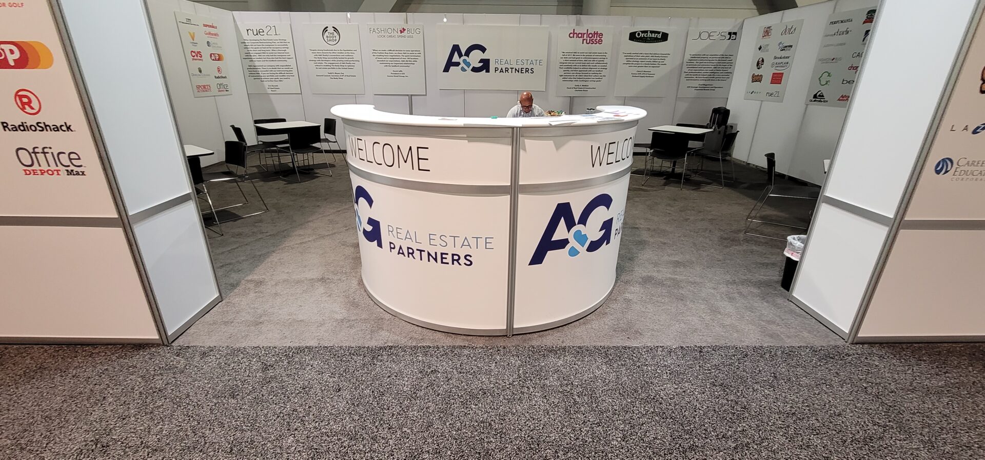A welcome counter for AG Real Estate Partners booth